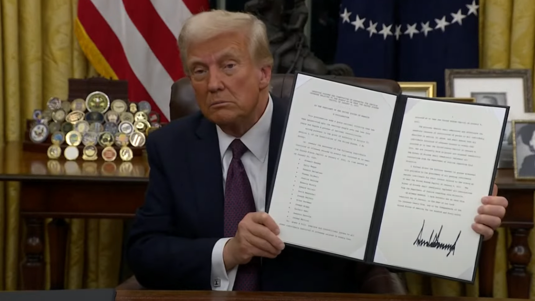 President Trump shows his signature for the first executive orders